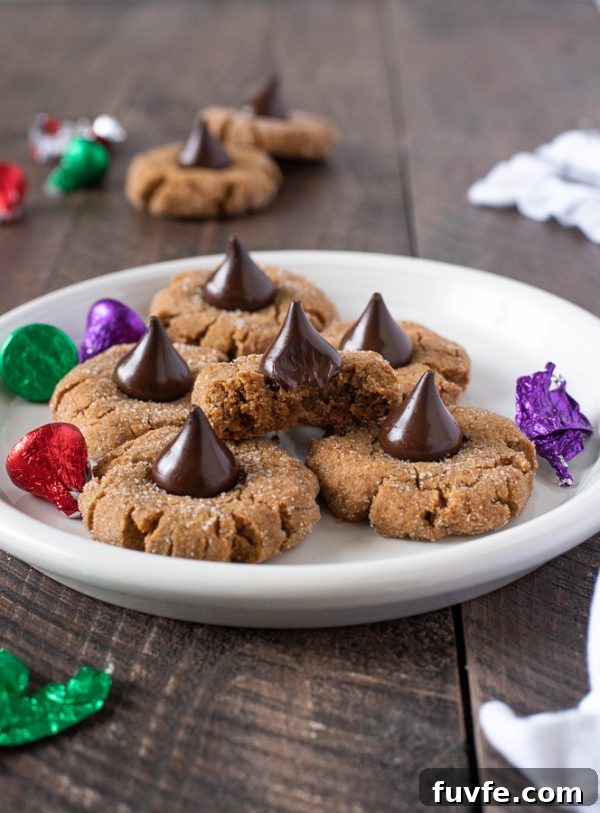 Gluten-Free Peanut Butter Blossom Cookies 8 gluten free peanut butter blossoms on a white plate with bite out of top cookie