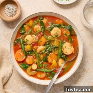 Instant pot vegetable soup in a bowl with parsley and pepper.