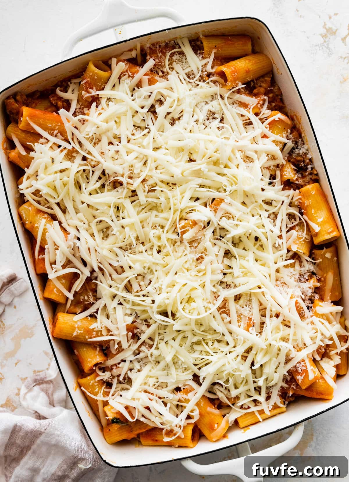 How to make classic pasta al forno step-by-step: add final cheese on top.