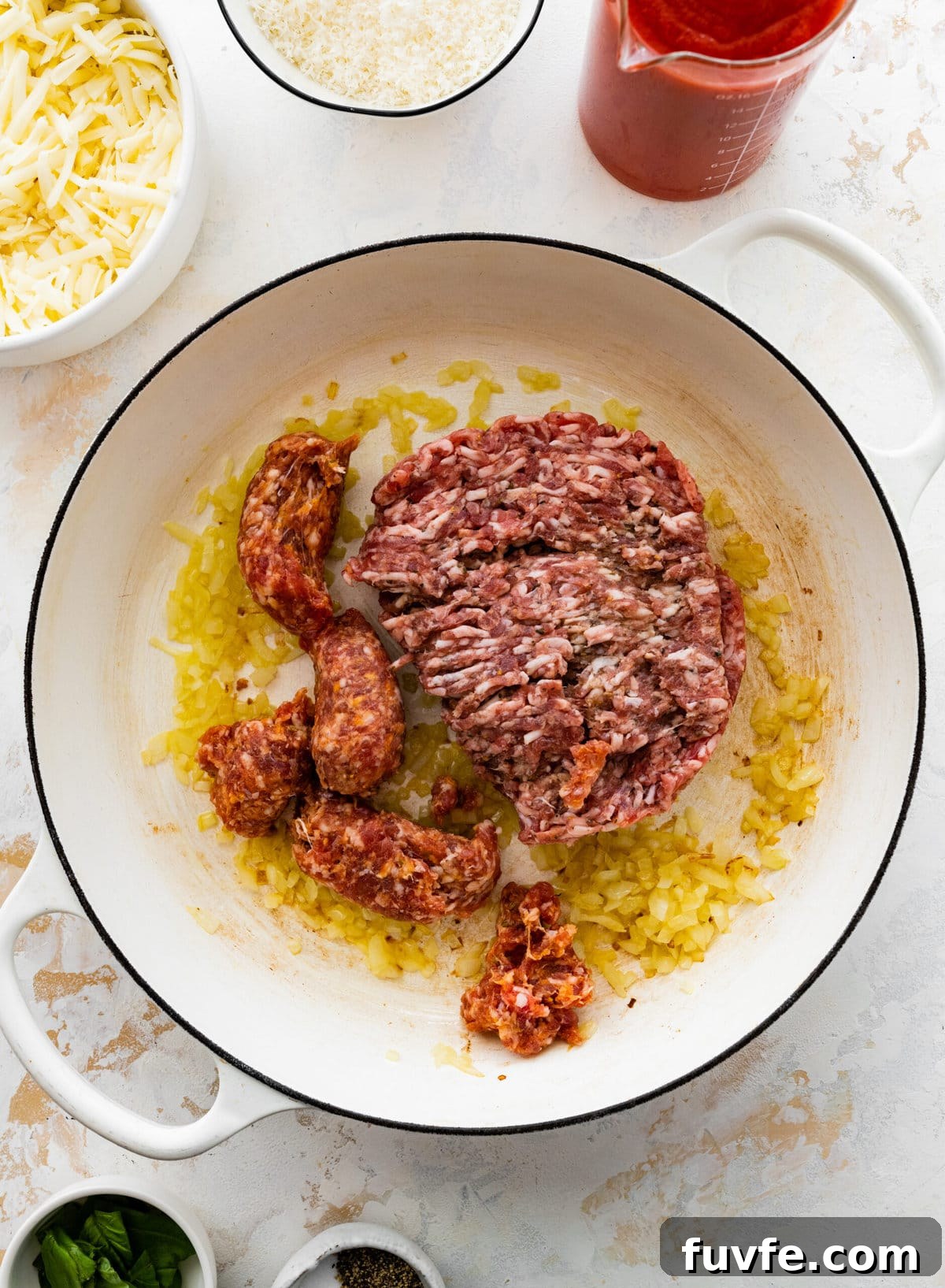 How to make classic pasta al forno step-by-step: brown the onions and meat in a pan.