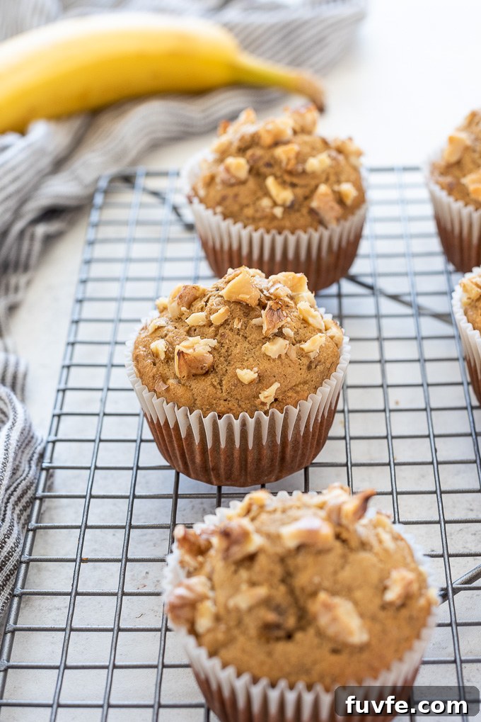 Moist Banana Oat Flour Muffins Recipe 5 Gluten-free banana oat flour muffins on a wire rack.