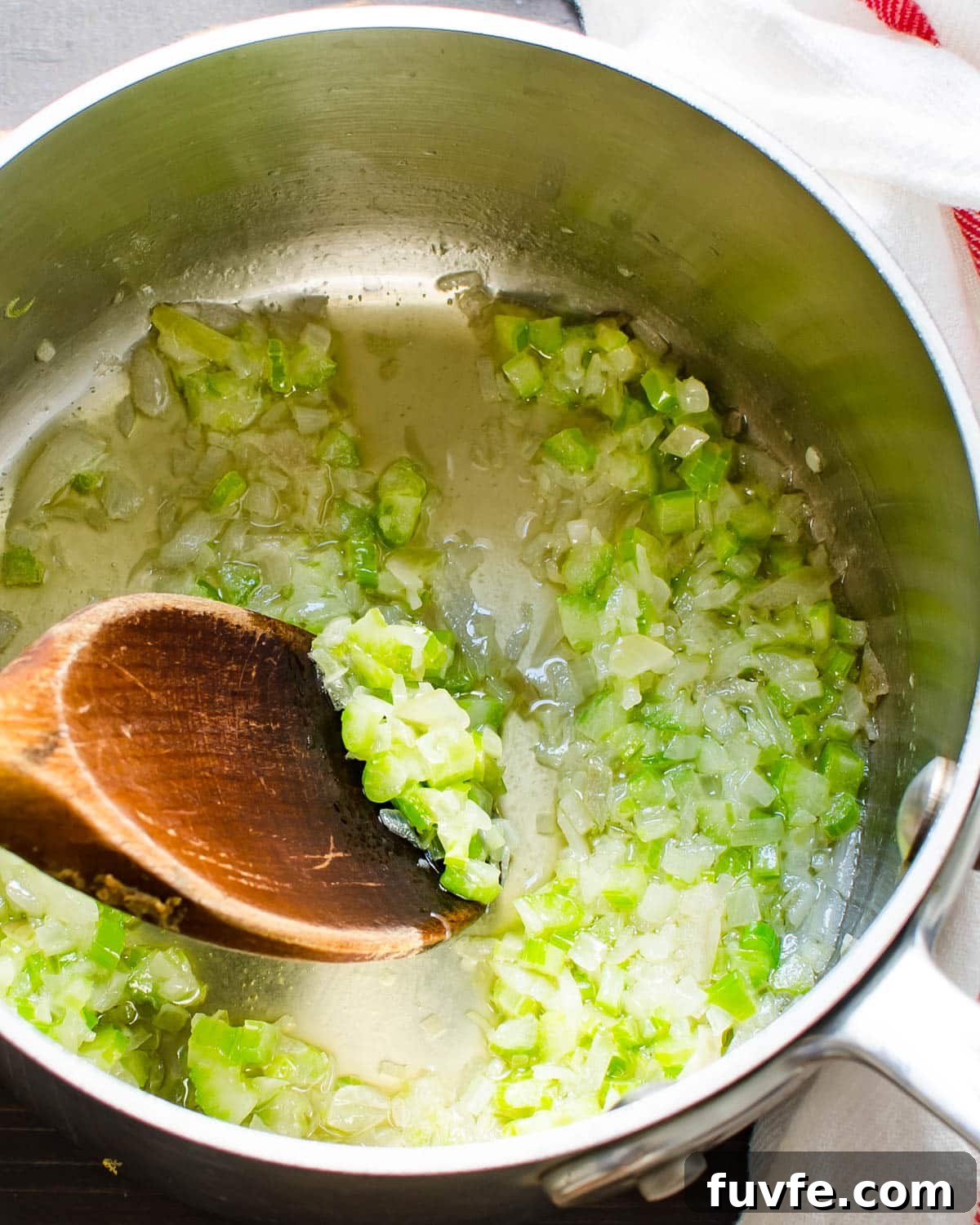 Traditional Oyster Stew Recipe: Creamy New England Style 5 sweating onions and celery in a pot.