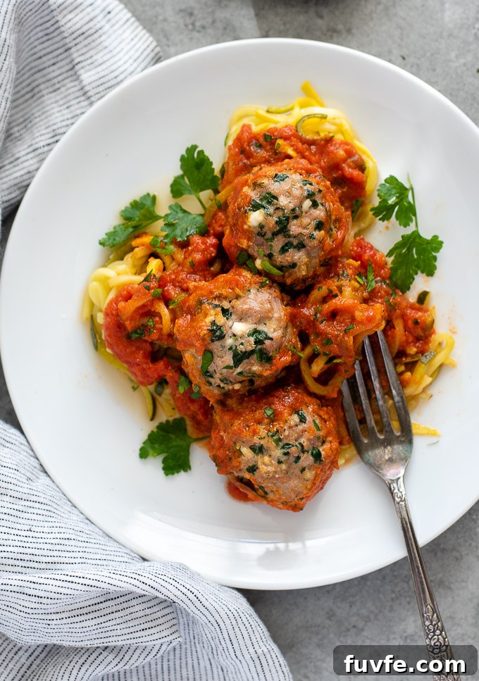 Baked turkey meatballs on a plate over zoodles