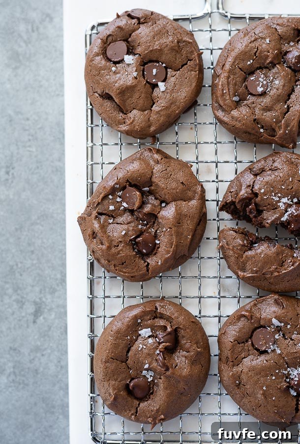 Close up of chocolate peanut butter gluten free cookies on wire rack with sea salt on top