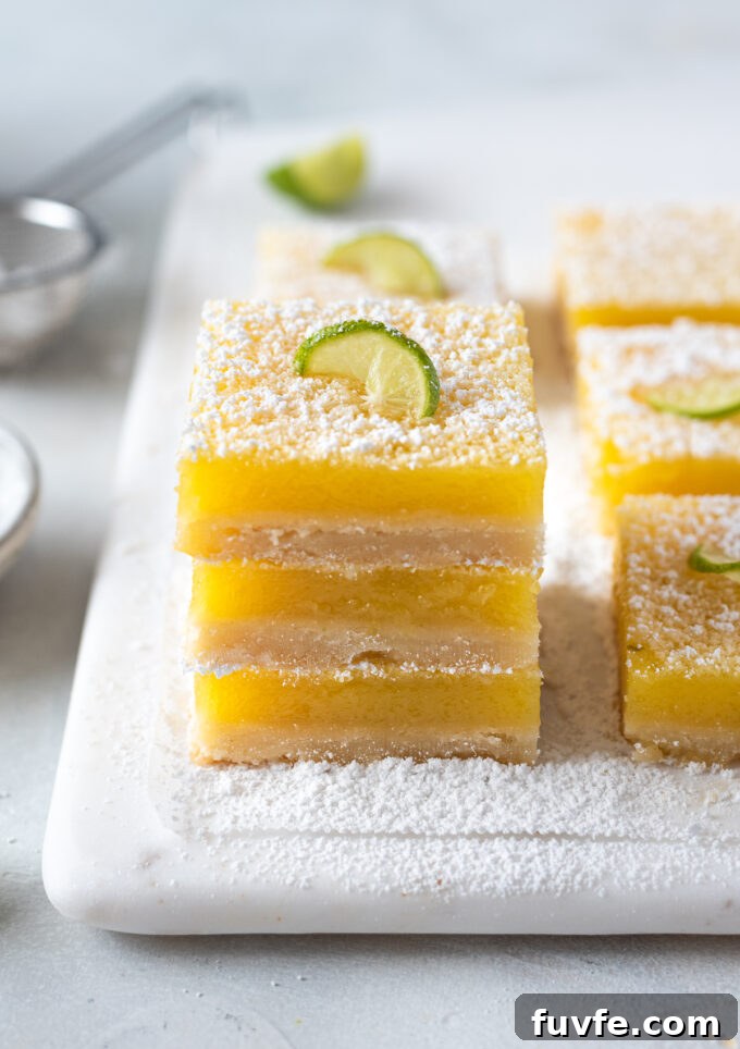 Zesty Key Lime Shortbread Bars Recipe 2 Key lime shortbread bars stacked on top of each other.