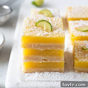 Zesty Key Lime Shortbread Bars Recipe 12 Key lime shortbread bars stacked on top of each other.