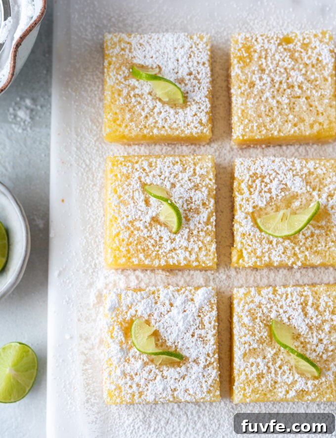 Zesty Key Lime Shortbread Bars Recipe 3 Key lime bars cut into squares with powdered sugar.