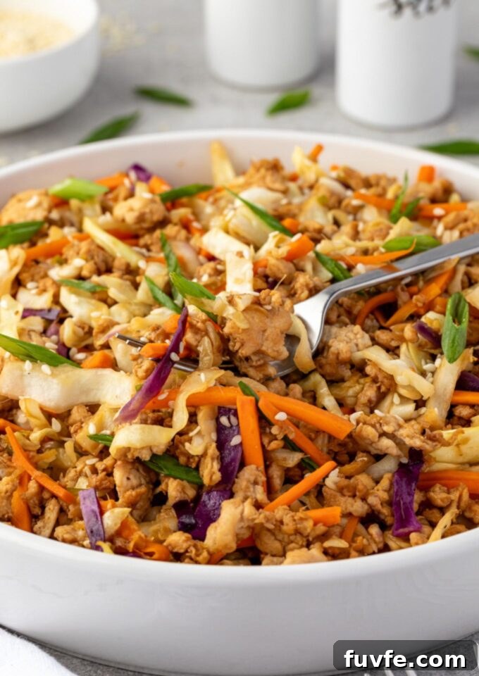 Egg roll in a bowl with fork digging in