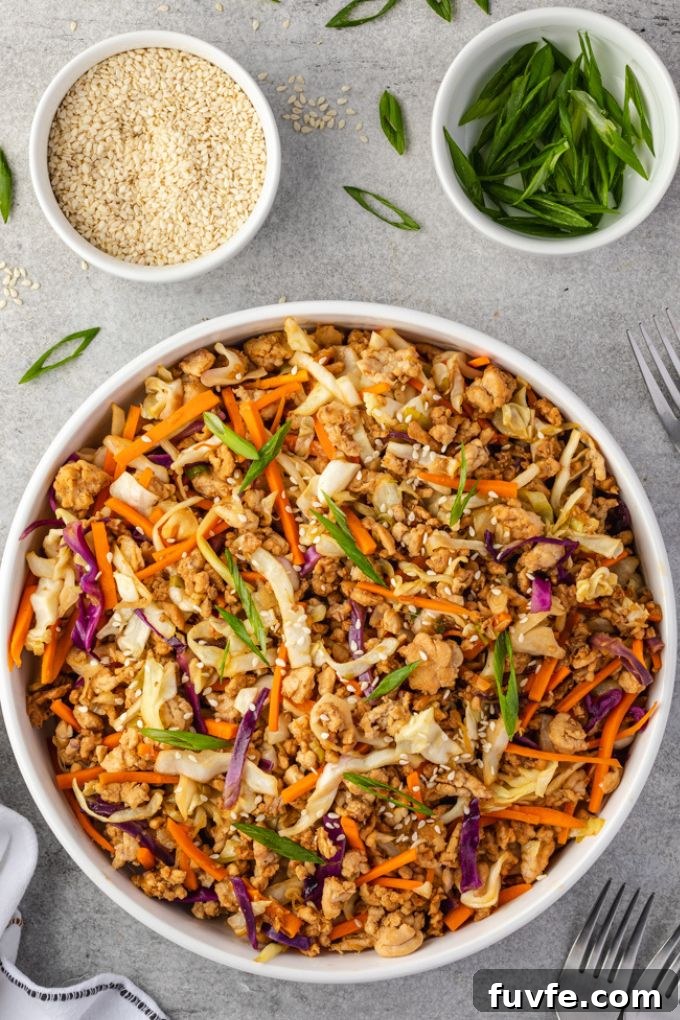 Egg Roll Bowl Recipe: Asian-Style Stir-Fry 3 Egg roll bowl with cilantro and sesame seed garnishes