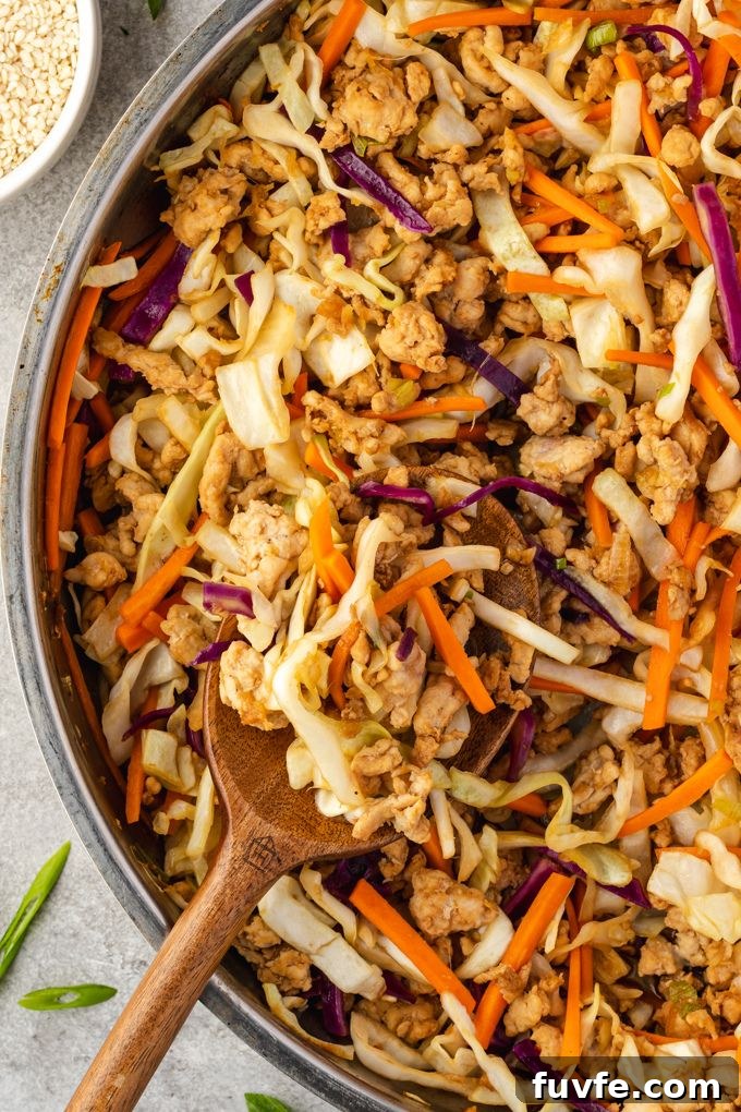 Egg Roll Bowl Recipe: Asian-Style Stir-Fry 6 Egg roll in a bowl in a skillet with wooden spoon