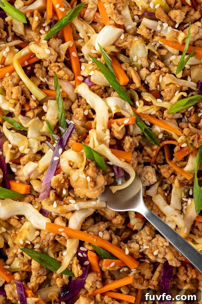 Egg Roll Bowl Recipe: Asian-Style Stir-Fry 7 Fork full of egg roll in a bowl