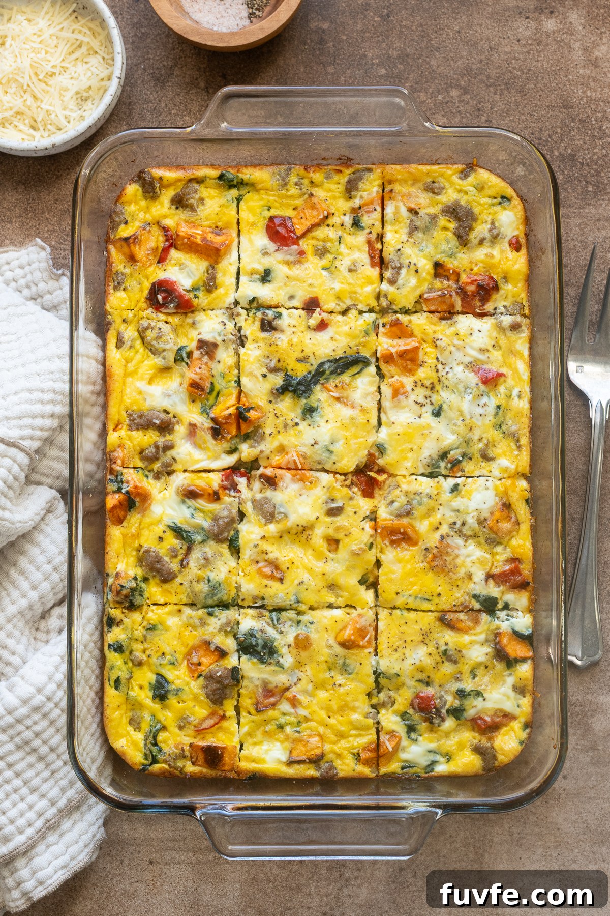 Sausage and egg breakfast casserole sliced in baking dish.
