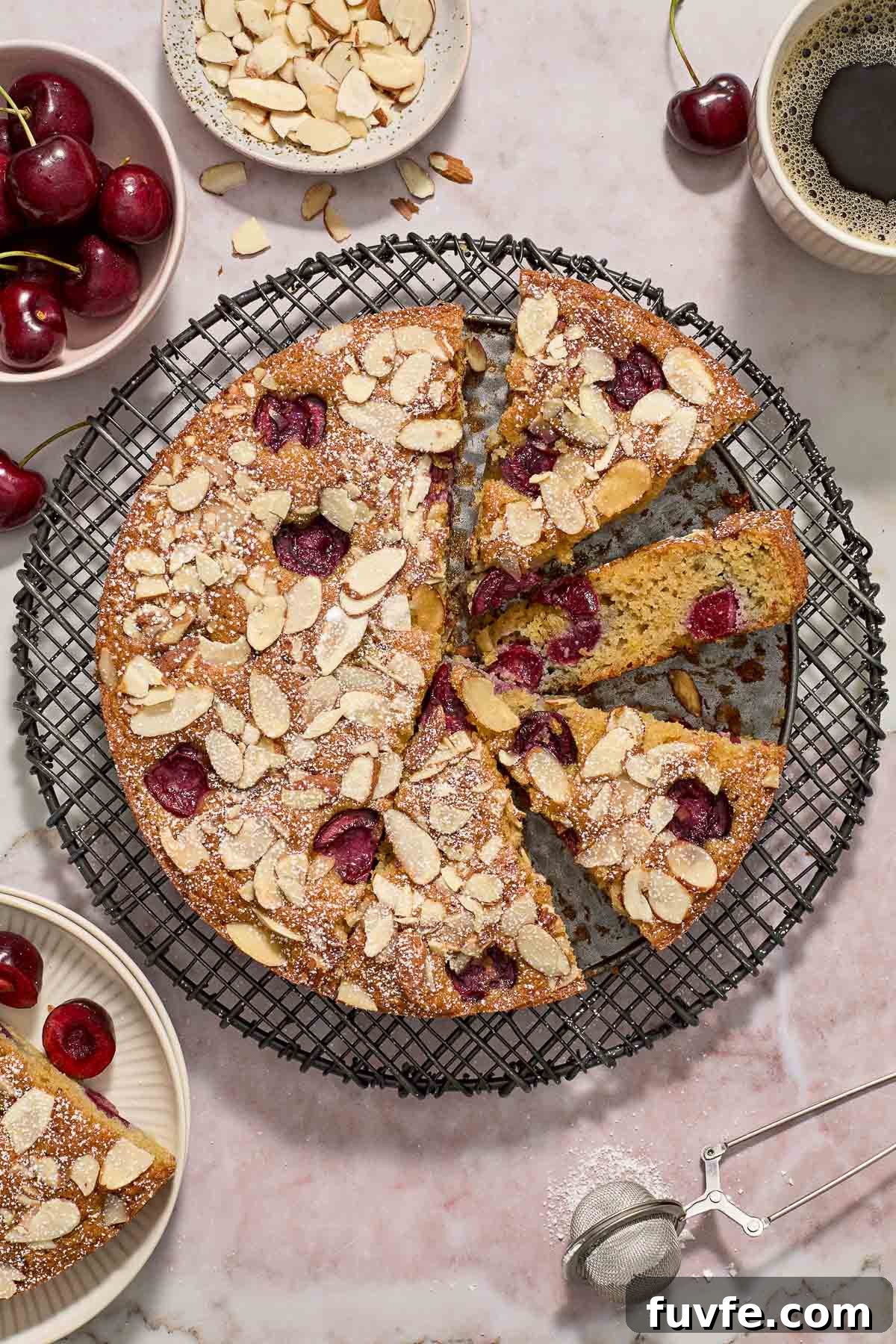 Cherry almond cake sliced on a wire rack.
