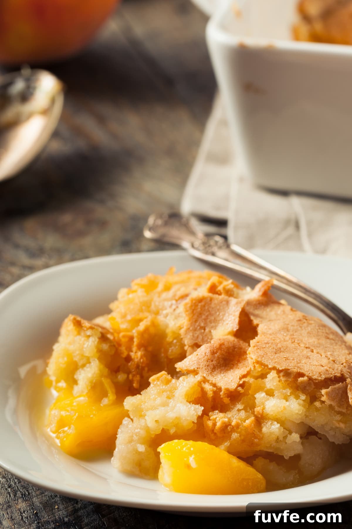 peach cobbler in white bowl