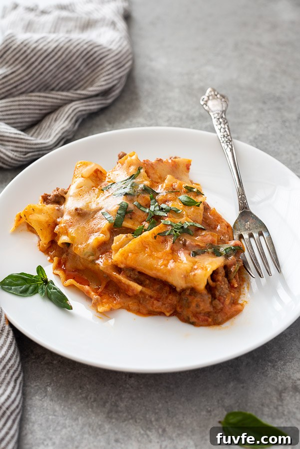 close up of one pot lasagna on a plate with fork alongside