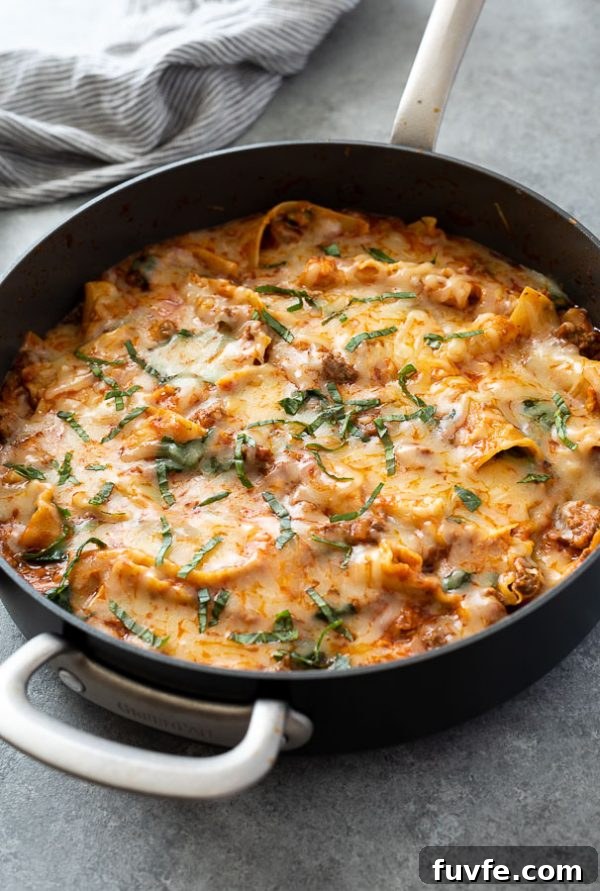 One-Pan Skillet Lasagna Recipe with Melty Mozzarella 5 front shot of skillet lasagna in pan with basil on top