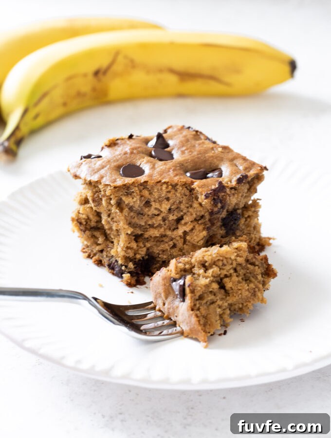 Moist Banana Snack Cake Recipe for Lunchboxes 2 Slice of banana snack cake on a plate.