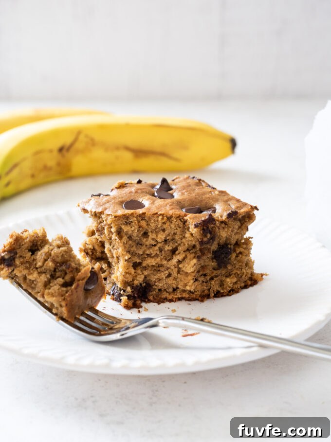 Moist Banana Snack Cake Recipe for Lunchboxes 6 Banana oat cake on a plate with fork.