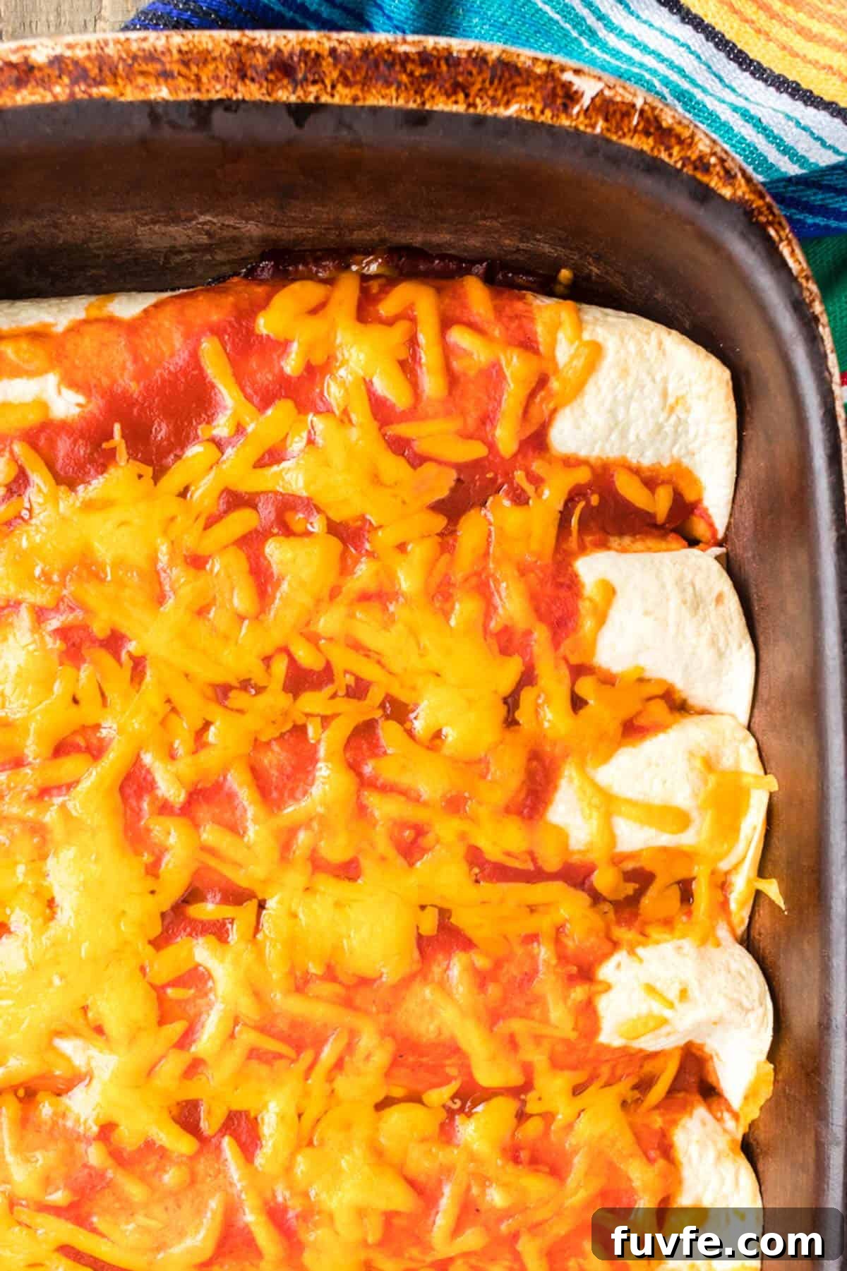 A pan of food with cheese on top.