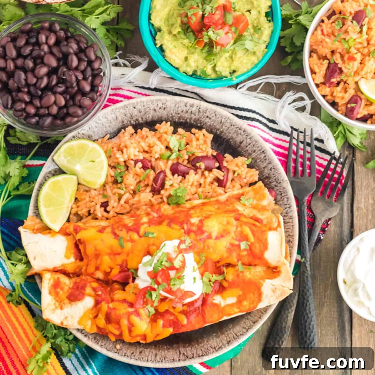 A plate of enchiladas with black beans and gaucamole.