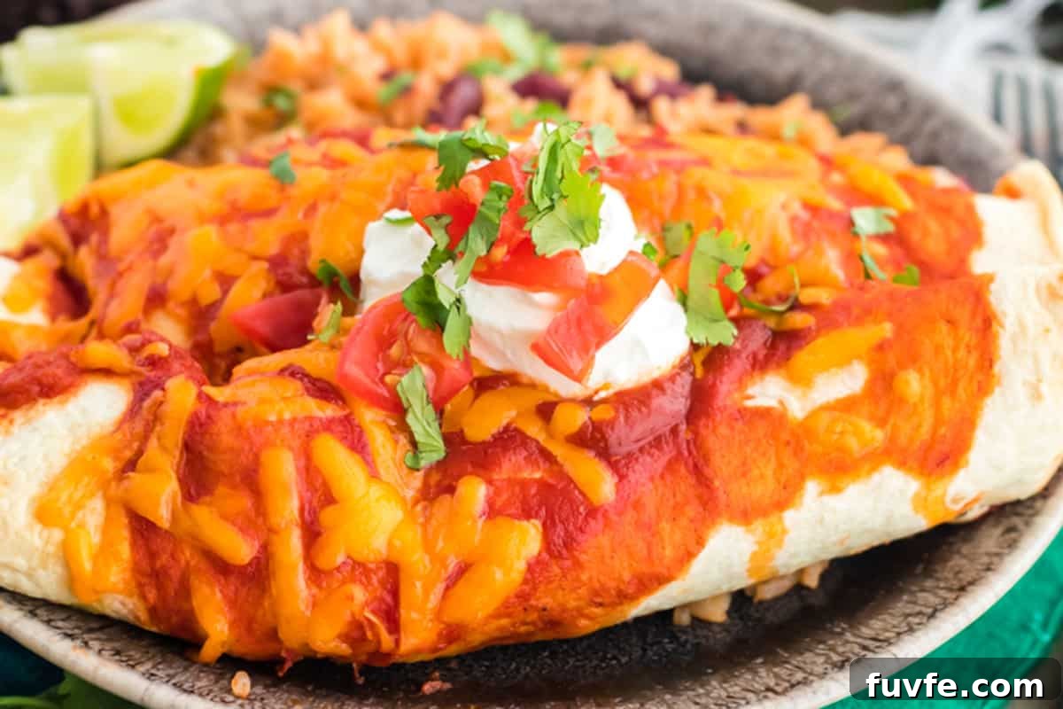 A plate of enchiladas with sour cream.