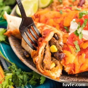 Table fork cutting into a beef enchilada