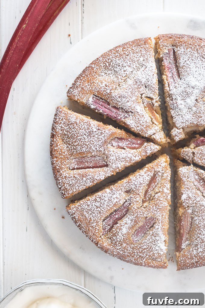 Rhubarb almond cake sliced with powdered sugar