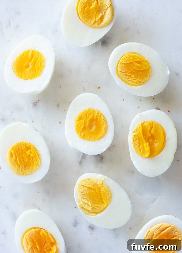 hard boiled eggs cut in half on a marble board