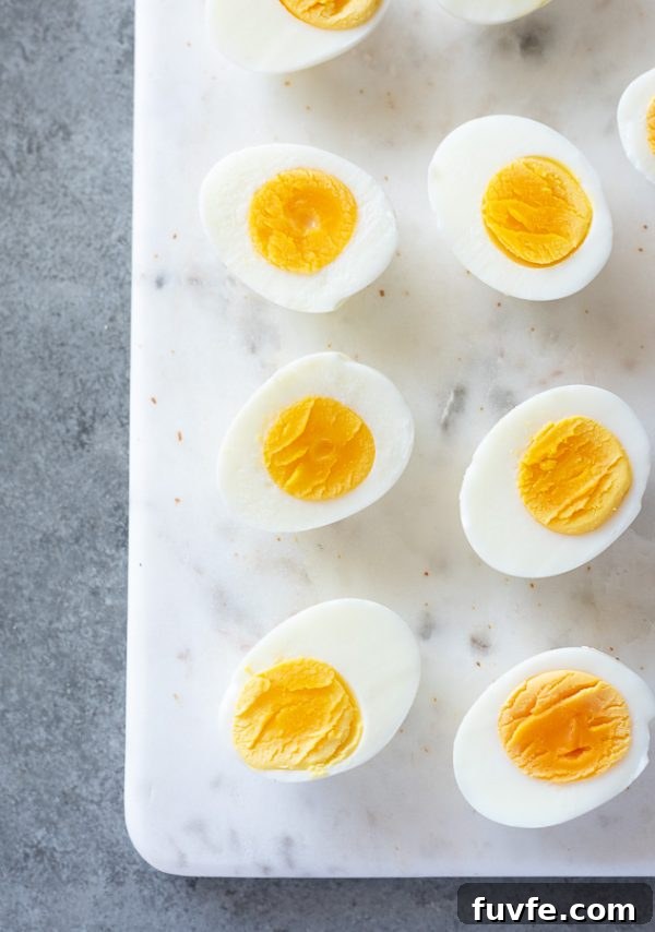 How to Make Perfect Hard-Boiled Eggs Every Time 6 easy hard boiled eggs lined up on a marble board