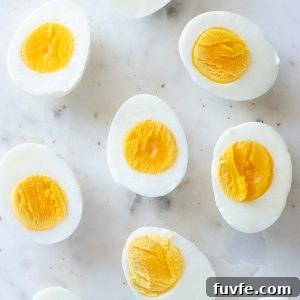 hard boiled eggs cut in half on a marble board