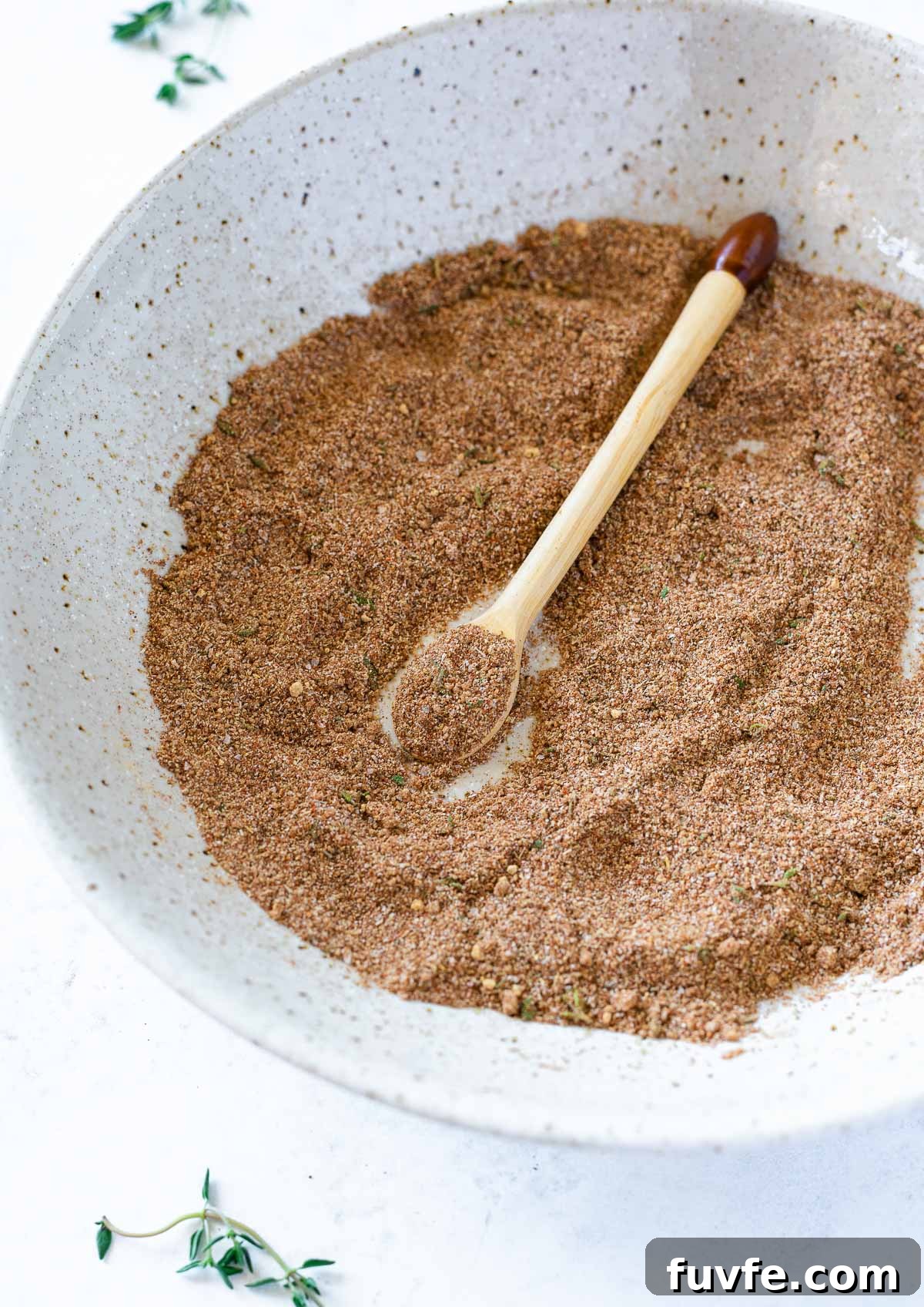 Authentic Jamaican Jerk Seasoning Recipe 4 Homemade jerk seasoning in white bowl blended with spoon