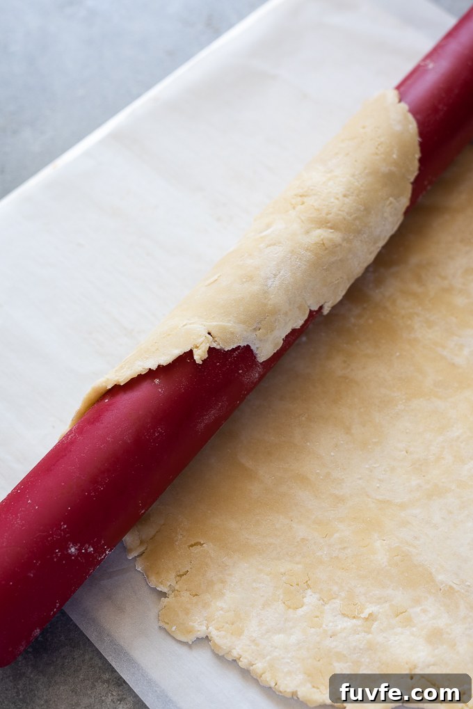 Roll the galette dough around a rolling pin and place on a baking sheet.