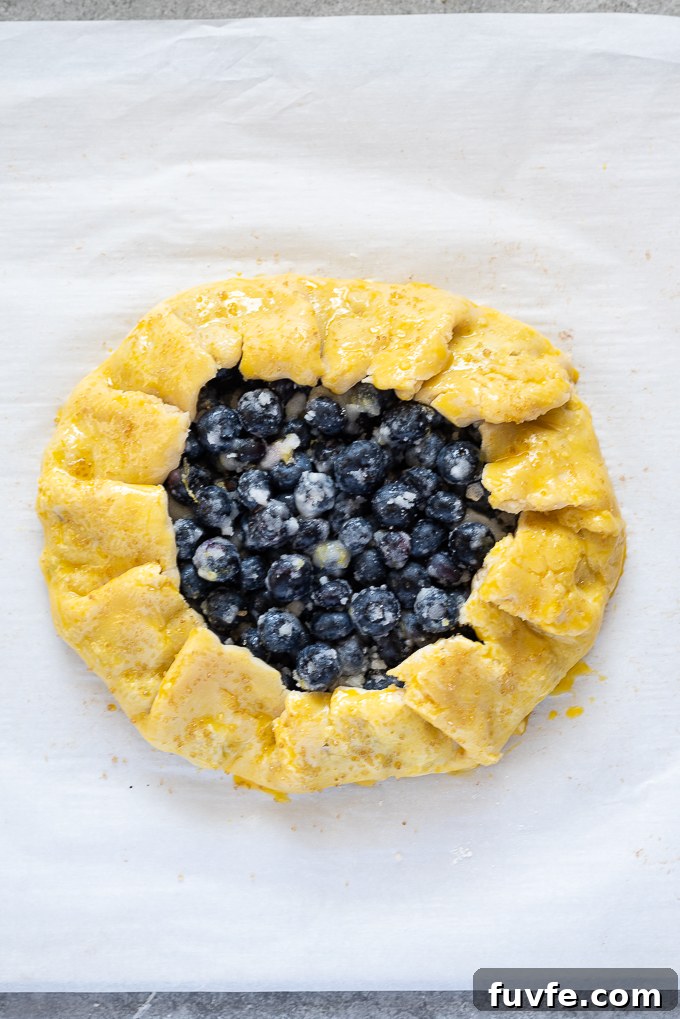 Blueberry galette before baking with egg wash.