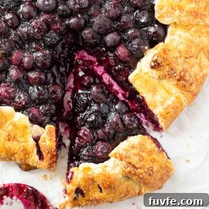 Blueberry galette with slice cut.