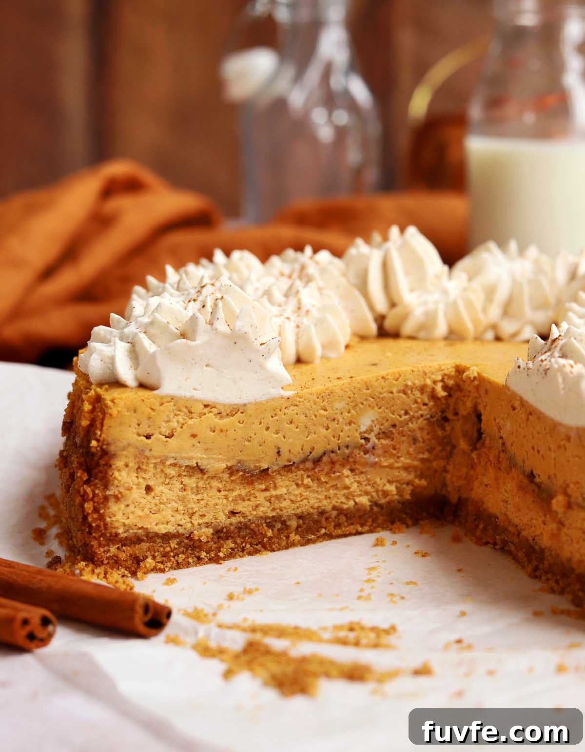 side view of cinnamon swirl pumpkin cheesecake showing cross section