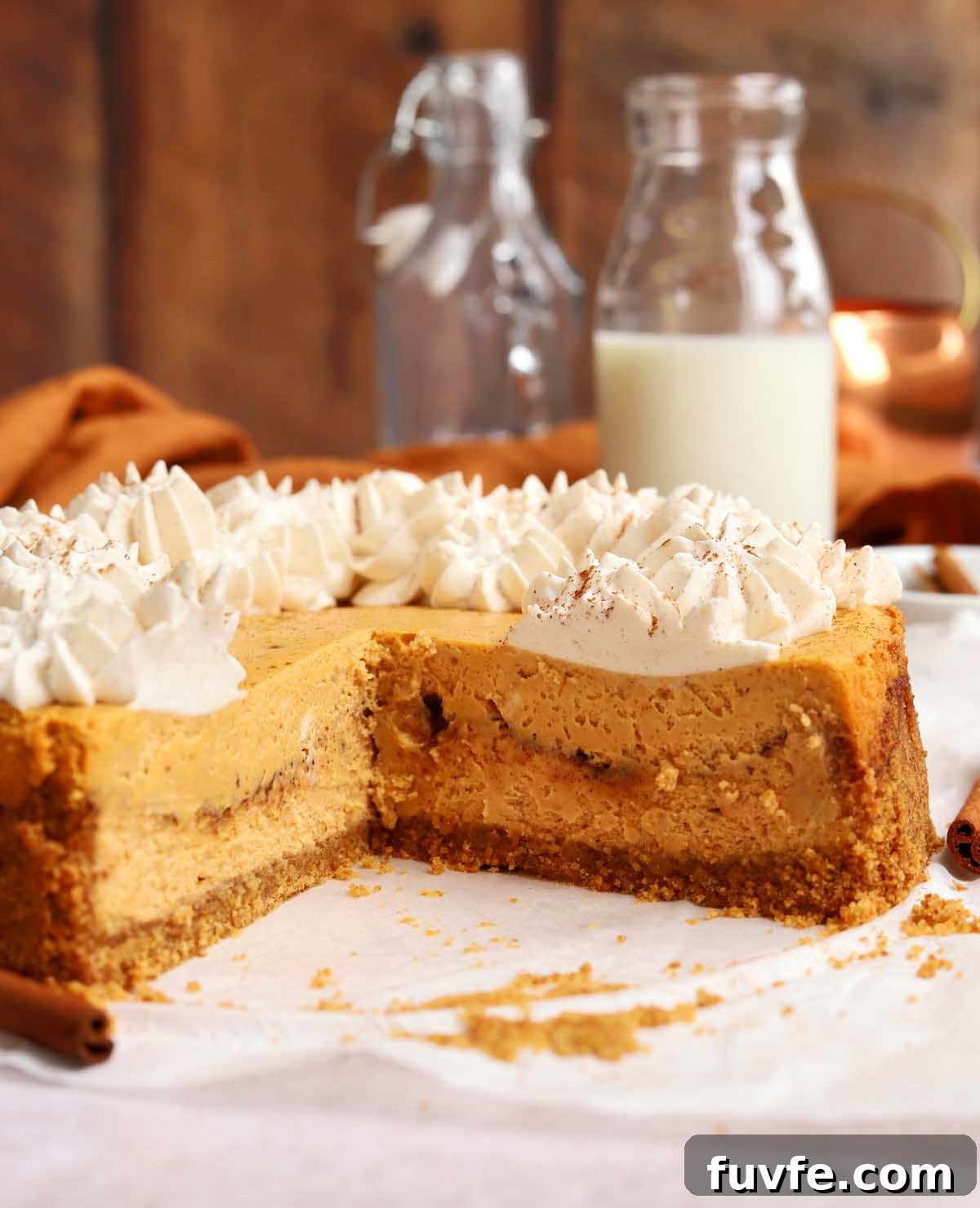 side view of cinnamon swirl pumpkin cheesecake showing cross section