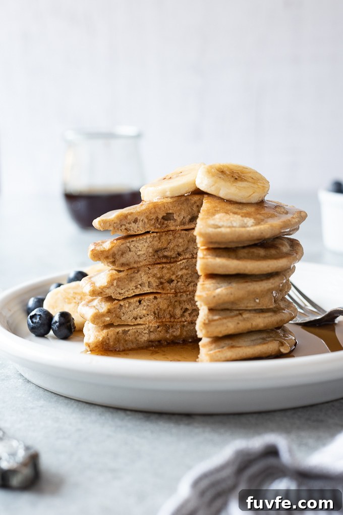 Gluten-Free Oat Flour Pancakes Recipe 6 Stack of oat flour banana pancakes with syrup dripping down