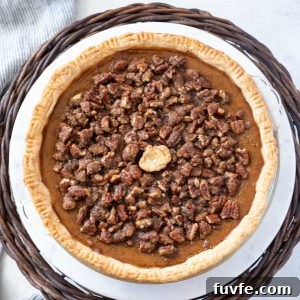 Pumpkin pecan pie on a cake stand