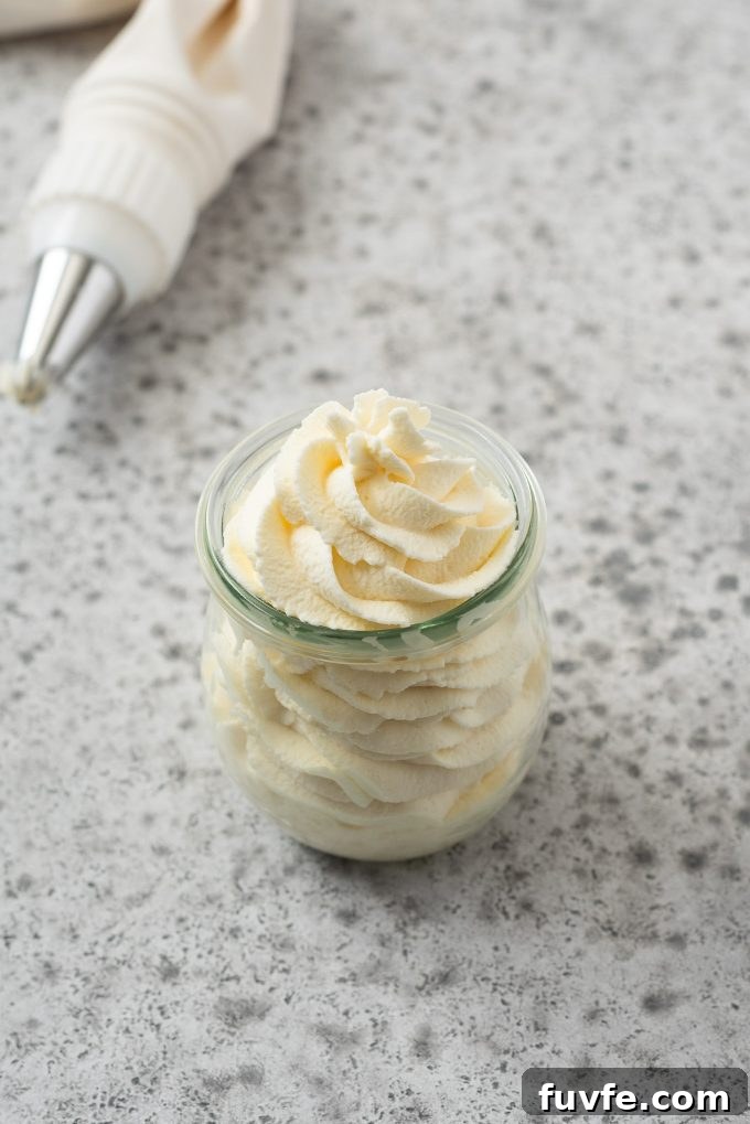 How to Make Homemade Whipped Cream for Stable, Fluffy Results 3 Angled view of jar filled with piped whipped cream