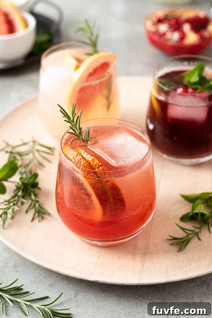 Blood orange vodka spritzer with rosemary sprig