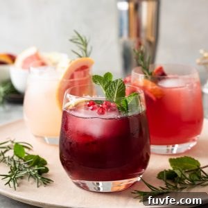 Vodka Spritzers on a server with herbs and cocktail shaker