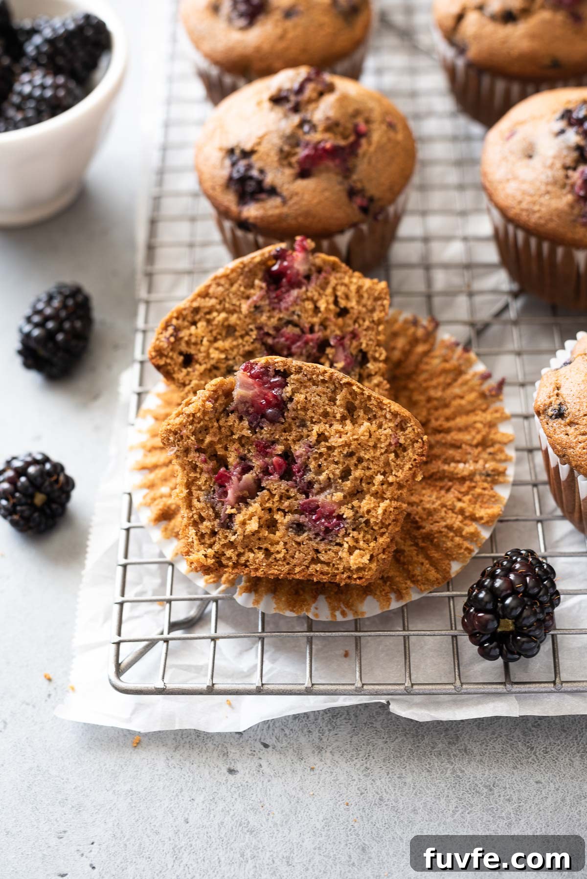 Homemade Blackberry Cinnamon Muffins Recipe 6 Blackberry muffin cut in half on paper liner
