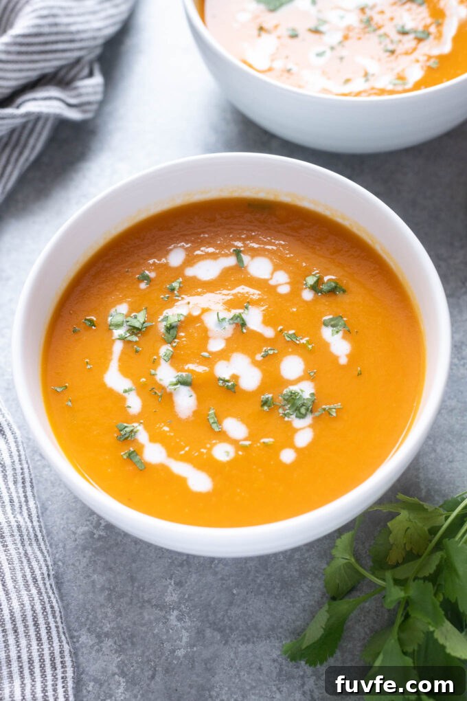 Carrot ginger soup topped with coconut milk and cilantro