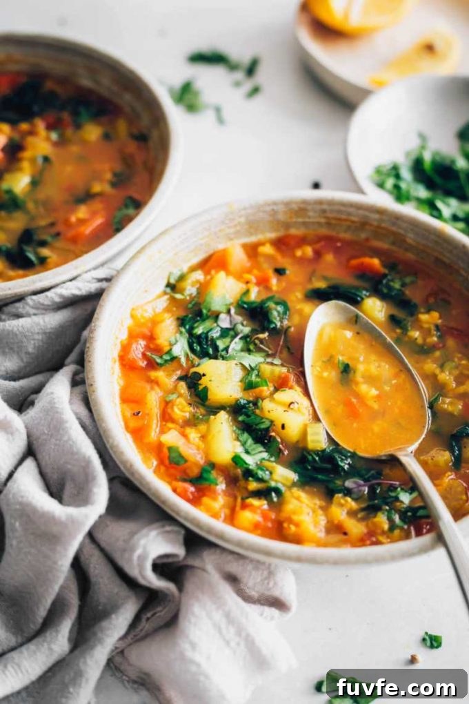 Vegan red lentil soup in a bowl with a spoon