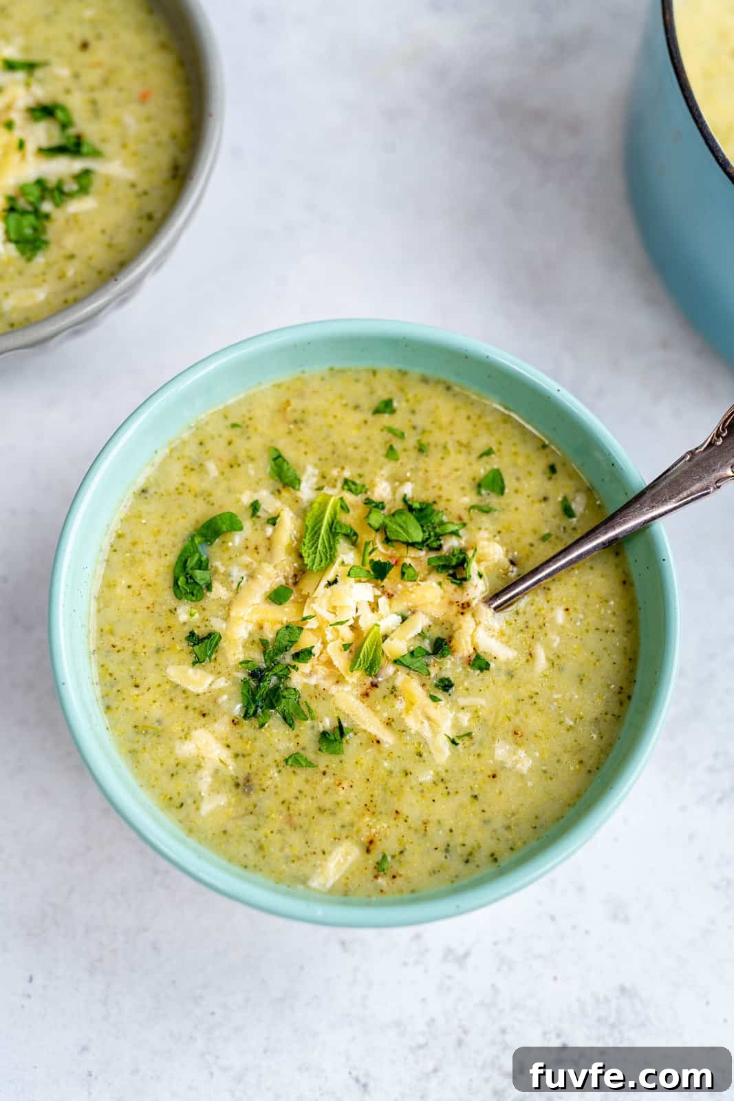 Broccoli soup in a bowl with spoon