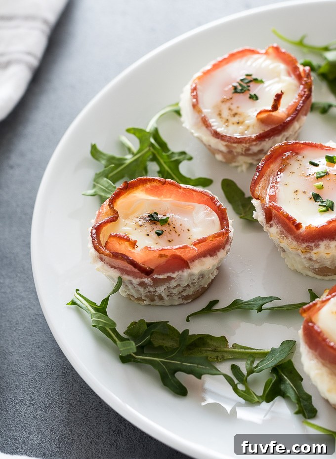 Bacon and egg cups on a plate with arugula