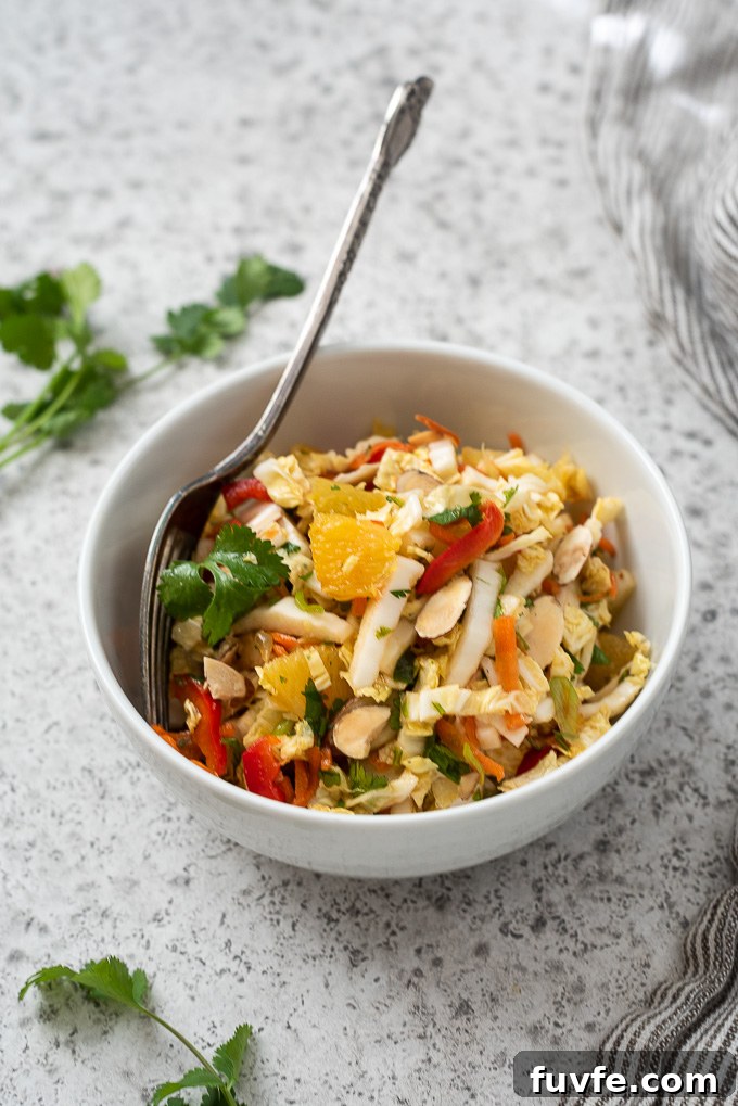 Bowl of napa cabbage salad with fork buried inside