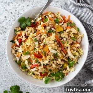 Napa cabbage salad in a white bowl with spoon
