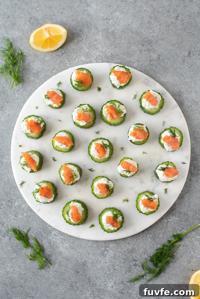 Smoked salmon cucumber bites on a round serving platter