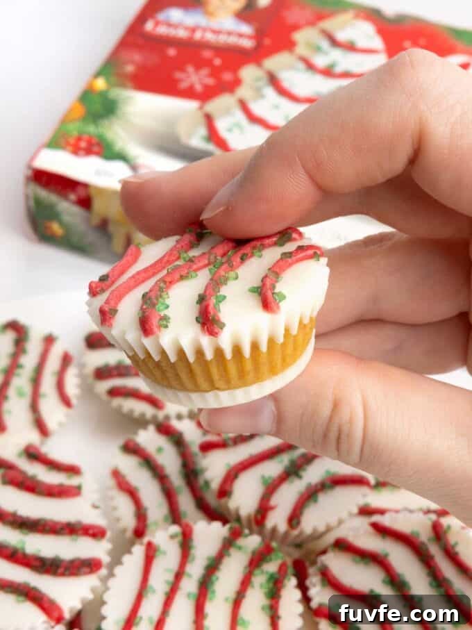Cake ball in a mini muffin tin that does not require dipping. Decorated as Little Debbie Christmas tree cake
